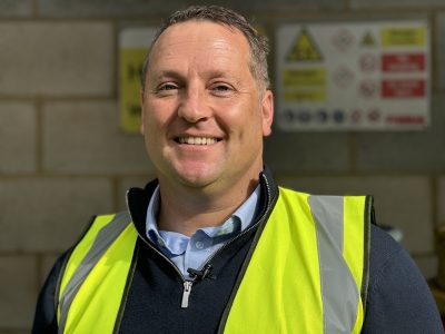 Richard Ellis of EXSolutions infront of EX flammable labels in a hazardous area